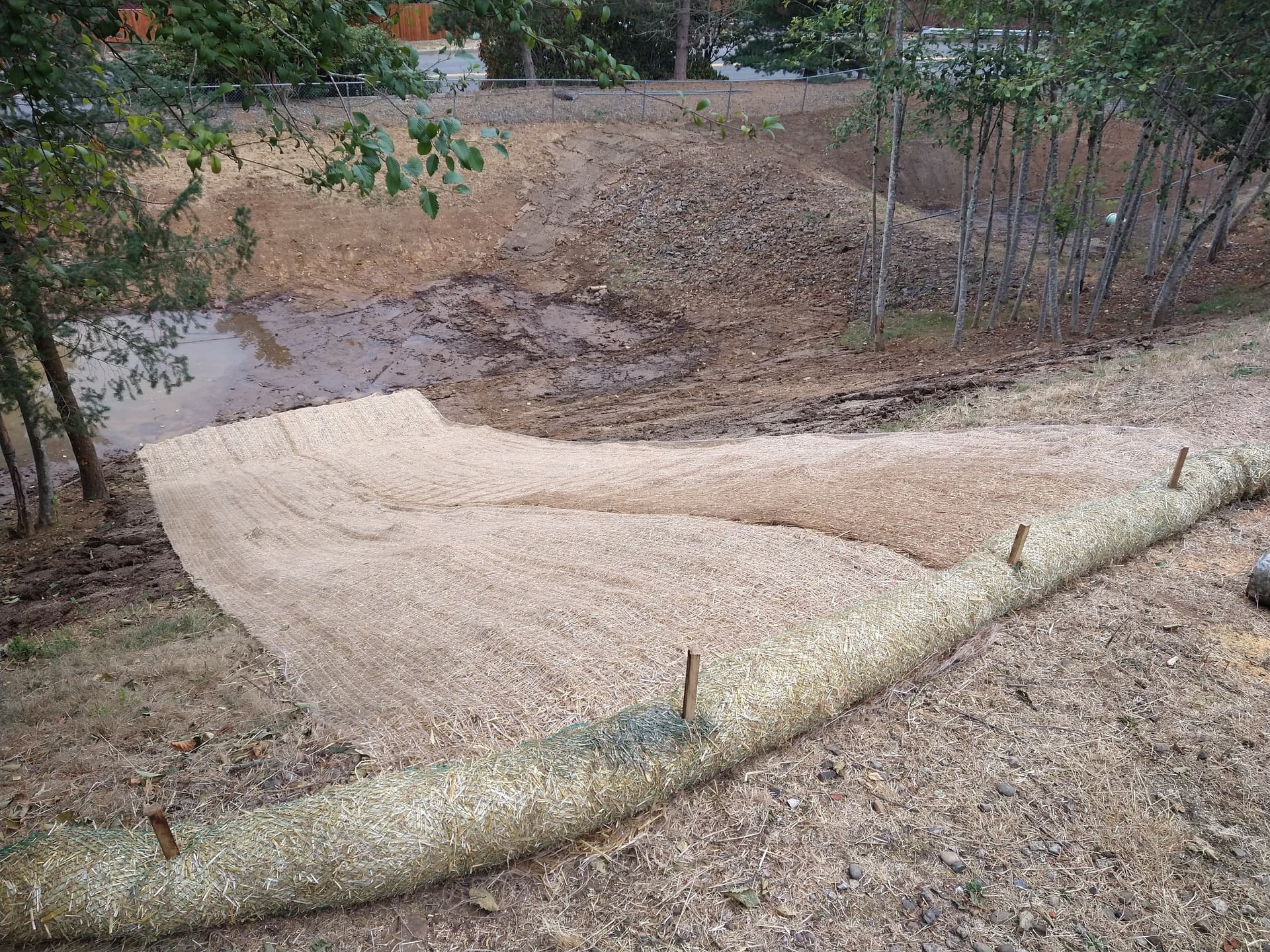 Erosion control blankets installed on slope with water pooling