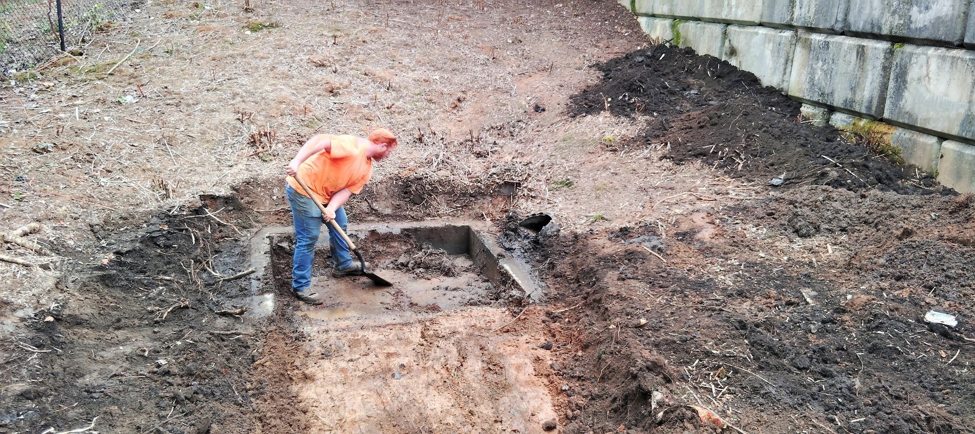 Close-up of trash rack with debris removal in progress