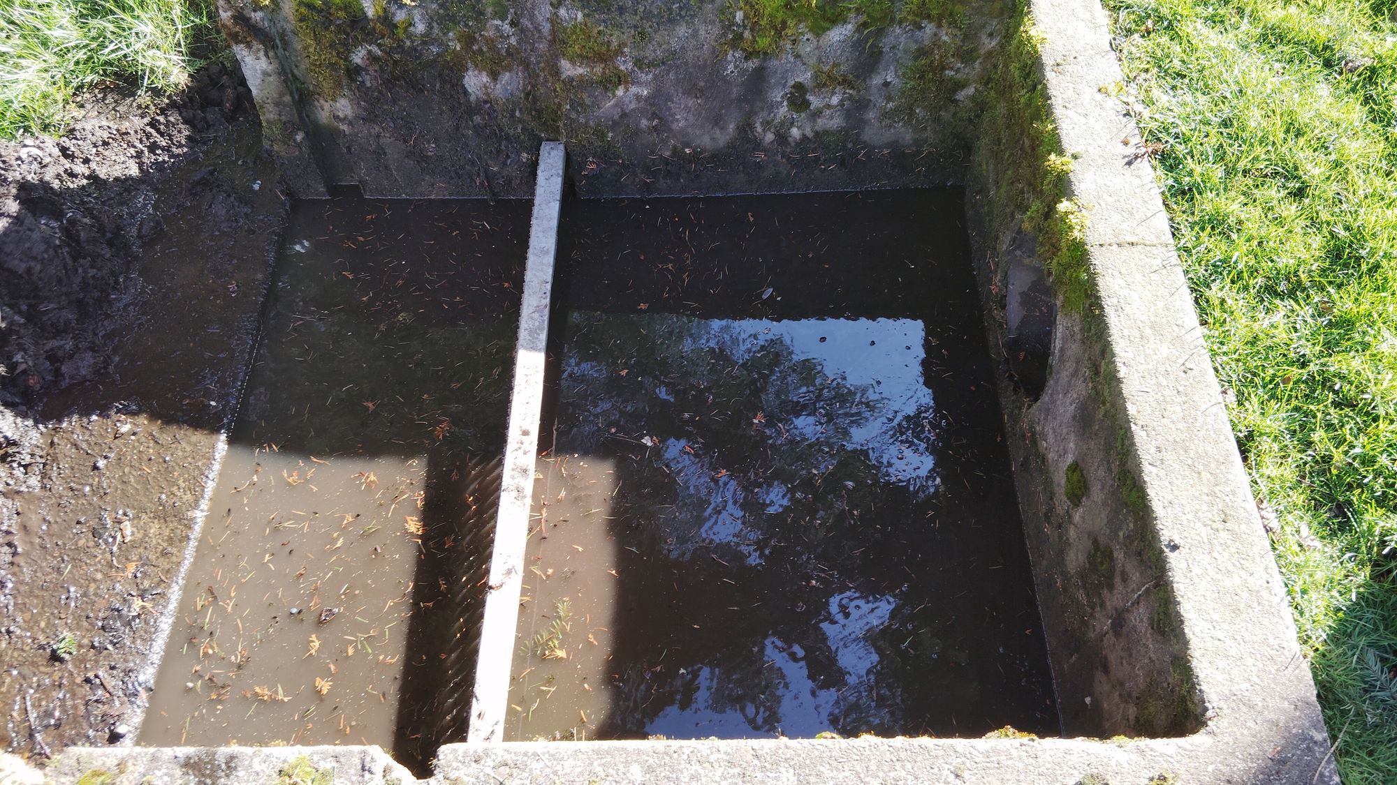 Trash rack maintenance showing heavy debris removal process